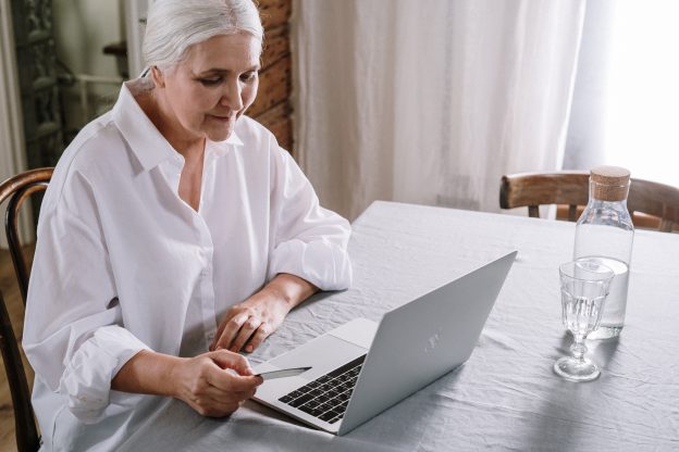 Women researching enhanced cash surrender value on a laptop