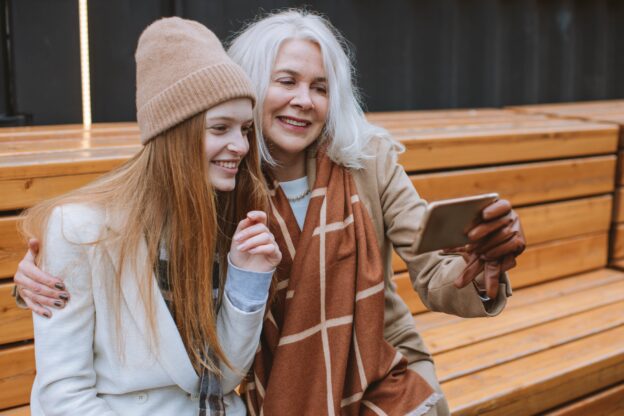 Grandmother and granddaughter sitting on a bench